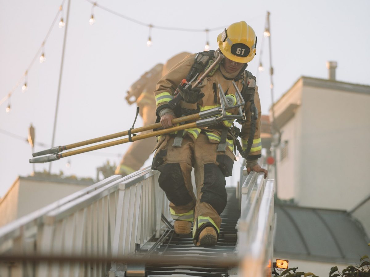 Firefighter climbing down ladder