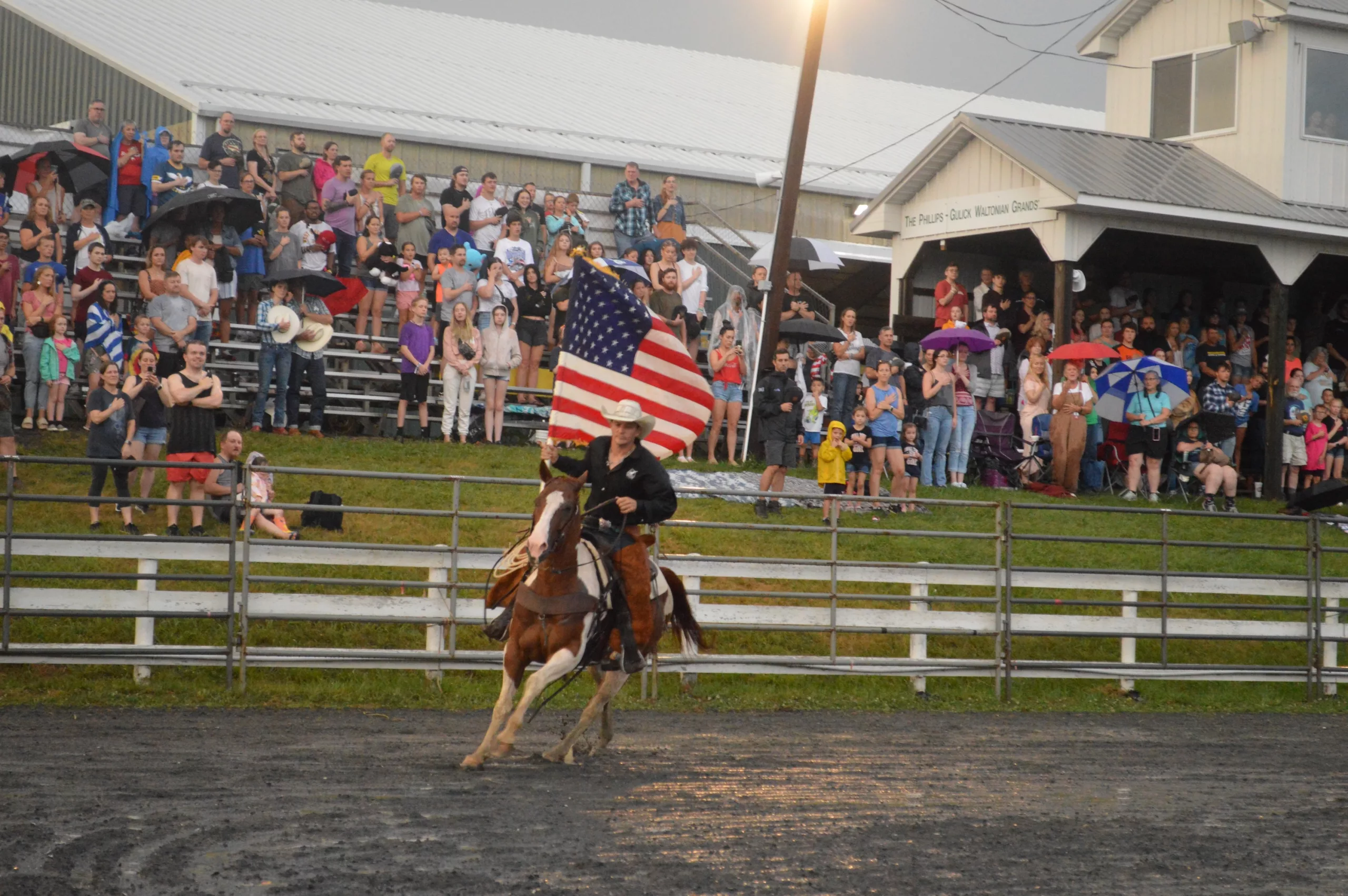 Cowboy riding his horse with the American flag